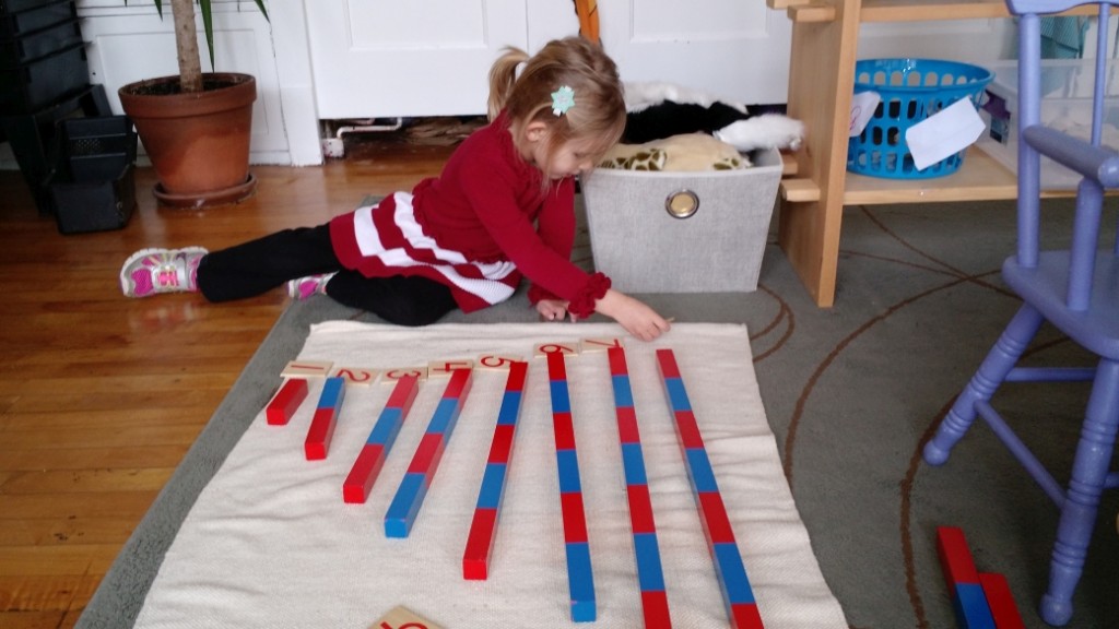 A student works with the number rods to develop concept of number.